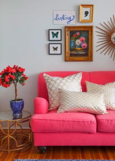 hot pink couch with gold accent pillows