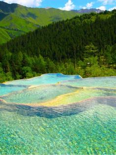 It seems that this place is actually Sichuan, China and not Canadian Mountain rock pools. Can anyone confirm where this is?