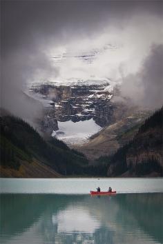 In this fabulous capture by Jeffrey Pang, we see two canoers paddling through Lake Louise as a break in the clouds reveals the majestic Victoria Glacier in the background. Lake Louise is a glacial lake located in Banff National Park in the province of Alberta, Canada.