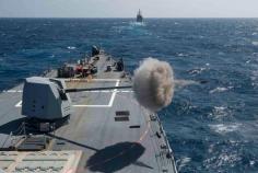 
                    
                        The guided-missile destroyer USS Farragut (DDG 99) fires its Mk 45 5-inch lightweight gun.
                    
                