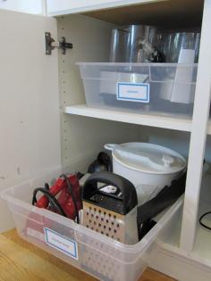 
                    
                        12 Easy Kitchen Organization Tips | Prentend kitchen cabinet pull-outs using large plastic storage tubs.
                    
                