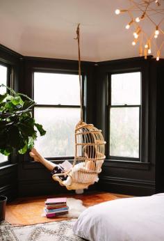 hanging chair / black walls- I always wanted bay windows. The black interior is astounding. I could live here.