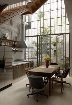 
                    
                        This Brazilian home has a wall of windows extending to the second floor. Imagine enjoying a view onto your courtyard while eating your morning toast.
                    
                