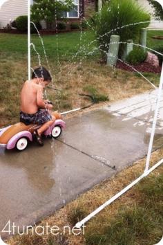 summer fun in the sprinkler made out of PVC pipes