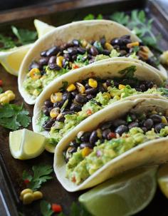 
                    
                        Loaded Guacamole Vegetarian Tacos from SoupAddict.com.  Veggie-loaded guacamole tacos with black beans, corn, and peppers. Vegetarian, vegan, and full-on yummy.
                    
                