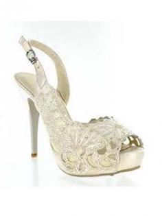 
                    
                        Lovely peep toe bridal shoes in a pearlescent ivory faux leather. Cutout floral design studded with rhinestone crystals.
                    
                