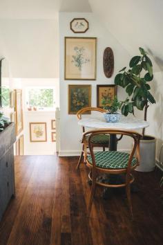 
                    
                        Charming small eating / breakfast nook - Bentwood chairs / vintage art / white walls / dark wood floors
                    
                