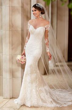 
                    
                        This Stella York Wedding Dress features romantic illusion lace sleeves, a glamorous chapel train, and fabric-covered buttons that adorn the illusion back and trail through to the gorgeous lace and tulle fabric.
                    
                