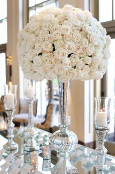
                    
                        This striking arrangement contains white roses in a silver floral vessel for a sophisticated touch.
                    
                