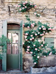 The Pink Roses look beautiful growing on the stone house really pop with the pretty green door ~ Provence, France