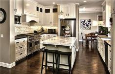Love the country white cabinets, dark hardware and dark wood floors. Dream kitchen