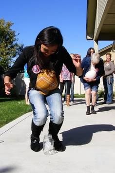 Tinkle in the Pot | Hilarious Baby Shower Game via @Kenzie Womack. Players put a balloon under their shirt while holding a ping pong ball between their knees. Players then waddle down the line and drop the ball into a jar.