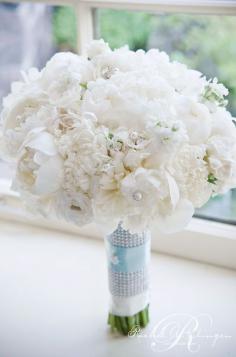 
                    
                        This glamorous bouquet creates a statement with crystal pins studding the arrangment of peonies and hydrangeas.
                    
                
