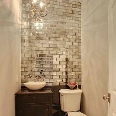 Love this small powder room, mirrored subway tiles as an accent wall in a powder room with no window. The antique nightstand makes a great small bathroom cabinet.