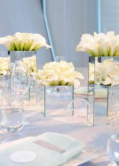 
                    
                        6. The architectural shape and variety of colors make calla lilies well suited for anything from a modern ballroom reception to an intimate ceremony on the beach. Colin Cowie Celebrations. #centerpiece #summerflowers #whiteflowers
                    
                