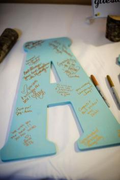 Spell out the last name and have guest sign it to hang up in your new house together. A useful "guest book"