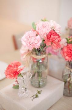 
                    
                        Mix and match blush and bold carnations for simple, yet chic centerpieces.
                    
                