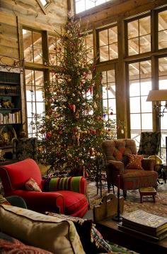 The breathtaking family Christmas tree features prominently in the windowed living room.