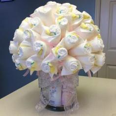 An alternative to the diaper cake. Check out the lotions at the base of the bouquet! #babyshower #diaperbouquet