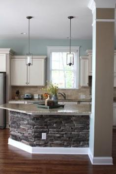 
                    
                        putting stone under the bar counter makes sense to minimize scuff marks when people are seated on stools around your breakfast bar...much better than painted wall...
                    
                