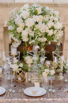 
                    
                        An elegant centerpiece, that will definitely draw attention, overflows with white blooms and lush greenery. Wedding Decorations, White Wedding Flowers, Centerpiece
                    
                