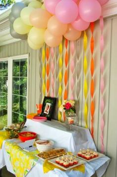 simple party backdrop with balloons and crepe paper