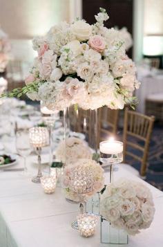 
                    
                        This beautiful centerpiece creates a romantic scene with the roses, hydrangeas, and peonies.
                    
                