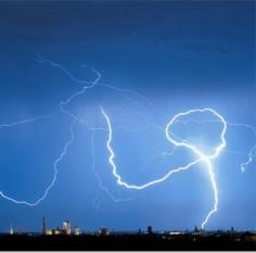 Cloud to cloud lightning decides to become a cloud to ground strike as it strikes a building in Munich. (© Peter Kneffel/AFP Photo/Getty Images)