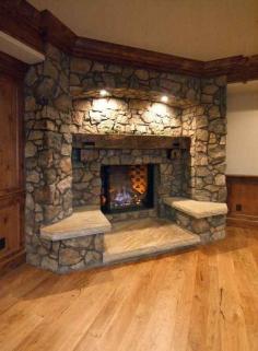 Stone fireplace with built in seating. Love! Basement!