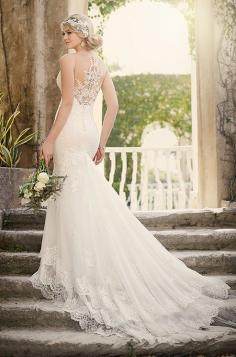 
                    
                        This fit-and-flare wedding dress from Essense of Australia bridal collection features beautiful illusion lace details. Finishing the gown is a unique three-tiered skirt and extra-long cascading train.
                    
                