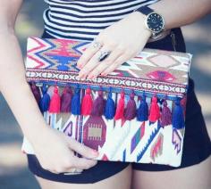 
                    
                        Embroidered fold-over clutch with colorful tassel detailing
                    
                