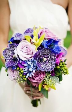 
                    
                        Toss-up on where to pin this unique bouquet ... freckled vanda orchids, bright chartreuse cymbidium orchids and hypericum berries, electric blue anemones, light blue agapanthus and lavender roses.
                    
                