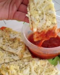Baked Cauliflower Cheese Sticks with Marinara Sauce  1/4 of a large head of cauliflower “riced”  1 teaspoon olive oil  2 cloves garlic, grated or minced  1 large egg (white), lightly beaten  1/2 Cup low fat mozzarella cheese  1/2 teaspoon dried Italian herb seasoning, divided  Marinara Sauce for dipping