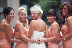 
                    
                        4 bridesmaids + bride in the middle looking back with arms and hands wrapped around each other. Captures a great shot from a different perspective.
                    
                