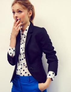 Black blazer, polka dot blouse and blue pants