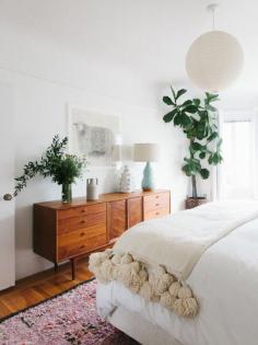 LOVE the teak/mid-cent-mod credenza! And the Berber blanket. bedroom, wood console table, plants, bedroom ideas, bedroom decor, white bedding