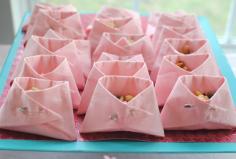 Great Baby Shower idea.  Paper Diapers: All you need is a package of napkins (your choice of color) and the appopriate amount of safety pins. SO easy and they make any treat that you’re serving look completely adorable. Obviously the smaller your napkins, the smaller your little diapers so buy the size according to what you are going to serve in them.  These also make awesome party favor bags!