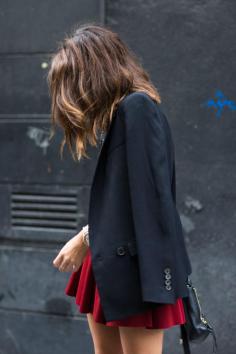 Street style. Red skirt, black blazer