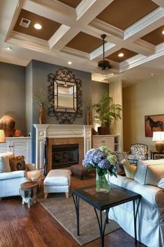 dramatic living room / family room Love the wall color above the fireplace.