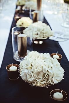 
                    
                        with white pillar candles and gold tea light holders. varying flowers in the mix of the hydrangeas
                    
                