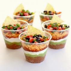 Mini seven layer dip. Great idea to keep a big dish of it from getting grody! This could also be great for any bean dip!
