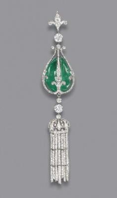 circa 1900, A BELLE EPOQUE EMERALD AND DIAMOND PENDANT The drilled emerald bead within the diamond fleur-de-lis cage, suspending a diamond crown with diamond line tassles, to the diamond collet and fleur-de-lis surmount, app. 4.72" high
