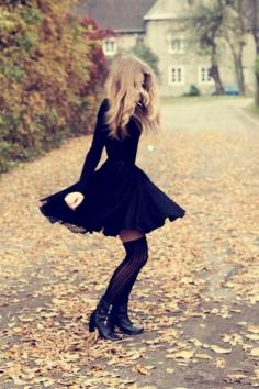 Beautiful little black dress with boots and knee high socks.
