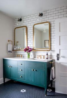 Love the teal cabinet, dual sinks, tiled floor, gold mirrors