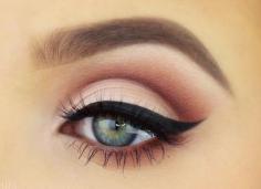 Simple eye makeup. Warm nudes and thick black winged eyeliner.