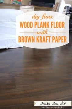 This is way too labor intensive, and doesn't have jack to do with the nursery, but omg, she used stain and brown paper to fake hardwood floors! Faux Wood Plank Floor Using Kraft Paper | Freckle Face Girl for Remodelaholic.com