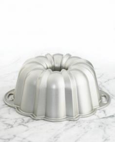 Made of commercial-quality heavy-duty cast aluminum. Heat-resistant exterior for even baking. Nonstick interior for easy release and cleanup. Dishwasher-safe rust- & warp-free 15-cup capacity. Dimensions: 10.25 diam. x 3.625H inches. Nordic Ware the designer of the original bundt pan created this Nordic Ware 50037 Platinum Collection Nonstick Cast Aluminum Anniversary 12 Cup Bundt Pan as its tribute to 60 years of delicious Bundt cakes. This amazing pan is constructed of commercial-quality durable heavy-duty cast aluminum that ensures sharp detail and uniform baking. The pan is from Nordic Ware's Platinum Bakeware collection and features handles that allow you to easily lift the pan leaving a beautifully formed bundt cake. The heat-reflective exterior ensures even baking and the nonstick interior assures quick release and cleanup. It's dishwasher-safe and will not rust or warp. 15-cup capacity. Dimensions: 10.25 diam. x 3.625H inches. Complete with lifetime manufacturer's warranty. About Nordic Ware. Founded in 1946 Nordic Ware is a family-owned American manufacturer of kitchenware products. From its home office in Minneapolis Minn. Nordic Ware markets an extensive line of quality cookware bakeware microwave and barbecue products. An innovative manufacturer and marketer Nordic Ware is best known for its Bundt Pan. Today there are nearly 60 million Bundt pans in kitchens across America. The Nordic Ware name is associated with the quality dependability and value recognized by millions of homemakers. The company's extensive finishing technology and history of quality innovation and consistency in this highly technical and specialized area makes it a true leader in the industrial coatings industry. Since founding Nordic Ware in 1946 the company has prided itself on providing long-lasting quality products that will be handed down through generations. Its business is firmly rooted in the trust dedication and talent of its employees a commitment to using quality materials and construction a desire to provide excellence in service to customers and never-ending research of consumer needs.