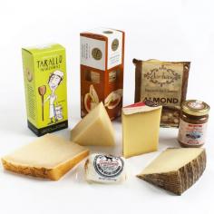 This collection includes: Comte Reserve: Each round of Comté reveals differences in the composition of its flavor, depending on the micro-region where it was produced, the season, the particular technique of the cheese maker, and the cellar where it was matured. It can always be called upon and never disappoints, whether as a table cheese or in a gratin. San Joaquin Gold: This is a new artisan cheese made by Fiscalini Farms of Modesto, California. It is semi-hard with a natural rind and a sweet, salty, buttery taste. The uniqueness of San Joaquin Gold impressed us in both its flavor and texture. Made from unpasteurized milk from Fiscalini's own herd of 1,400 Holstein cows, it is a wonderful cheese for snacking, but can also be used as a topping for soups or salads. Manchego: Manchego is Spain's most famous cheese. Produced in La Mancha in Central Spain, true Manchego is made from 100-percent sheep's milk. Grana Padano Stravecchio Oro del Tempo: Stravecchio Oro del Tempo is a superior, 22-month aged Grana Padano produced by Agriform near Venice. This masterpiece compares beautifully with its better-known cousin Parmigiano Reggiano. Chevre and Fruit by Coach Farms: Fresh fruit and a young chevre is a marriage made in heaven. Enjoy this pairing anytime with Coach Farm's new fresh goat cheese stuffed with fruit. These four ounce rolls of fresh goat cheese have a soft and sweet filling of real fruit. Monti Sibillini Pink Apple and Truffle Compote by Le Spiazzette: The two most precious and typical products of the Monti Sibillini area are used together to make an amazing sauce, combining perfectly the two flavors, pink apple & truffle. Daelias Biscuits for Cheese: Based on a traditional Mediterranean recipe, meant to complement all cheeses, soft and hard. These biscuits will not overwhelm your cheese, but will enhance it and cause you to crave for more. Australian Water Wheels: These light-as-air crisps come to us from Victoria, Australia. They are small, pressed crackers with a waffle-like impr