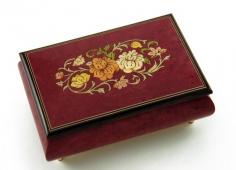 A truly wonderful show of old world craftsmanship! This intriguing red wine Italian musical jewelry box will make for a perfect gift. Whether it's for that someone special or beloved family member or friend, it's appropriate for just about any occasion. This amazing hand-made Italian music box features a traditional wood inlay design of a floral pattern embraced by the harmonious red wine stain and visible patterns of the natural burl-elm. This piece is entirely hand-made in Sorrento, Italy and is constructed using only the finest materials. The extraordinary exterior features is complimented by its plush interior. Listen as the wonders of sound fill the room with a melody only a traditional mechanical movement can produce. It will sure bring moments of tranquility time and time again. With over 380+ tunes available, you're sure to find that perfect melody. Please see "item options" for available tunes or visit our "listening station" for all song titles as well as sample clips. Thank you very much for your interest in our products! Your satisfaction is always guaranteed at the Attic! Dimensions: Length - 6.5" Width - 4.5" Height - 2.75