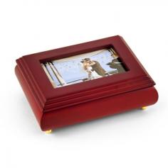 PRODUCT DETAILS: - 18 Note Movement (please see item options for available tunes) - Photo Frame Lid - Flat matte brown lacquer - 1 open compartment - 1 ring roll - Hand lined wine colored fabric - Wood construction